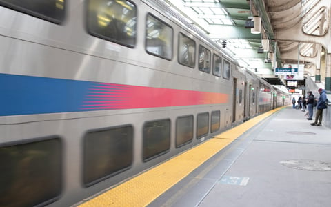 NJ TRANSIT train in motion at the station tracks. 