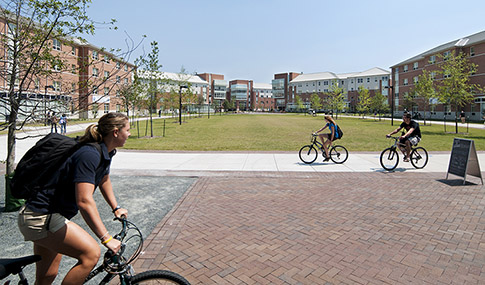 Students bike through Old Dominion University’s campus on a sunny day