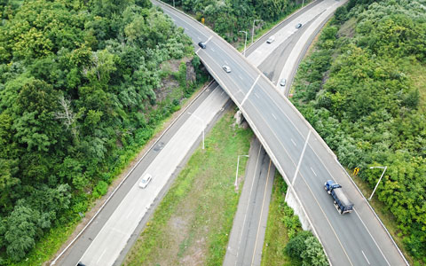 An aerial view of one of a bridge with roads running beneath it.