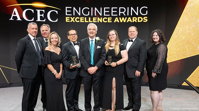 VHB employees stand with ACEC award