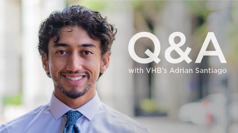 Adrian Santiago smiling in an office setting.