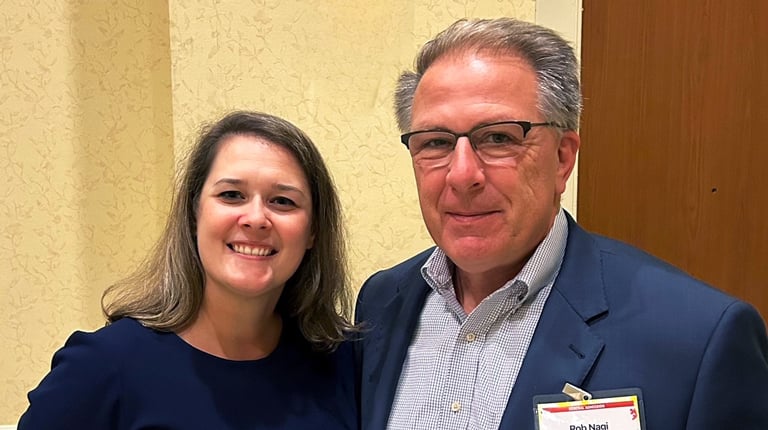 Rob Nagi and Brianne Belschner wearing business attire stand together at the awards ceremony.