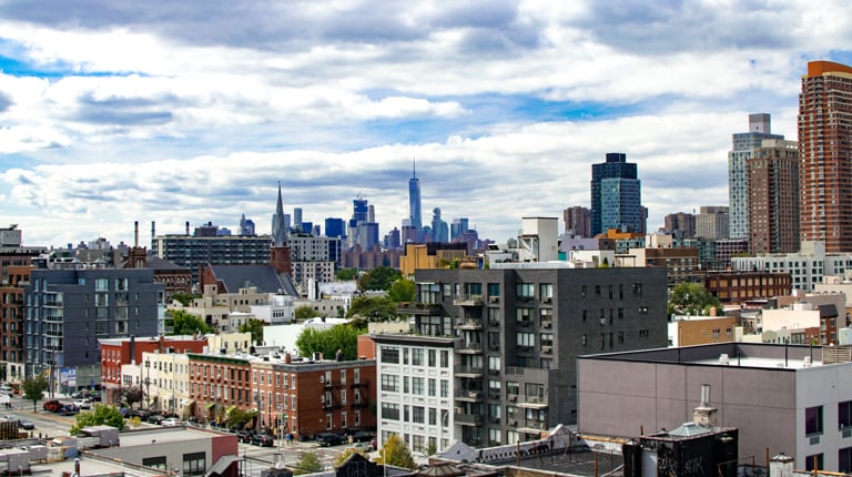 New York City buildings and clouds in the sky.