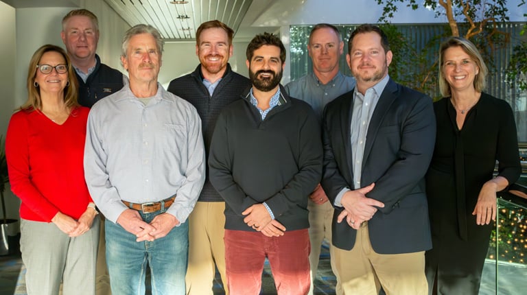 Eight people smiling at the camera