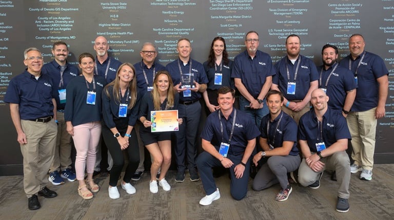 Large group of VHBers posing and smiling with a SAG Award certificate at the conference.