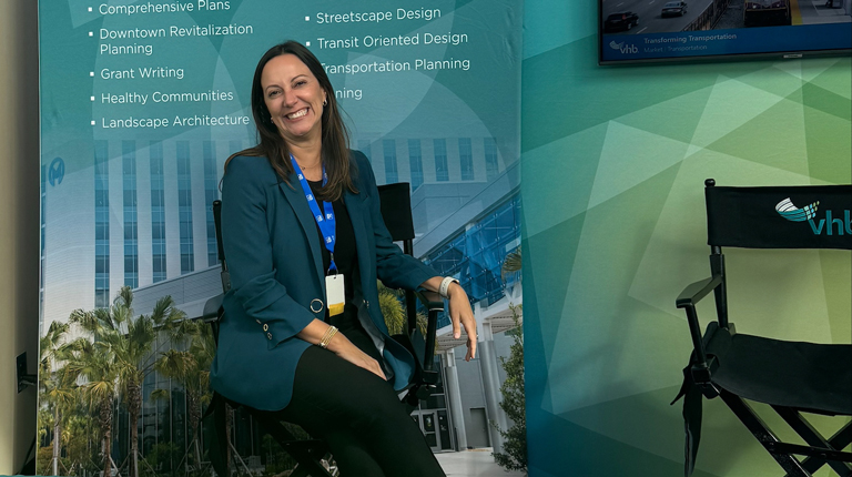 Roberta Fennessy smiles at a VHB conference booth.