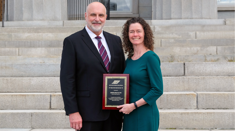 Jenn Conley accepts an award from the Vermont Secretary of Transportation.