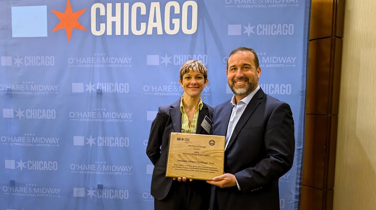 Two people holding an award