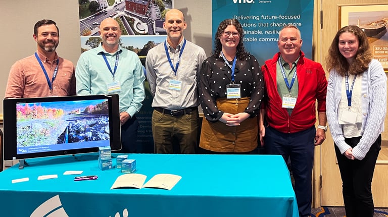 VHB Team members Garrison Beck, Eric Monkiewicz, Peter Smiar, Zelda Dively, Adam Bliss, and Caroline Herzog stand at the VHB table.