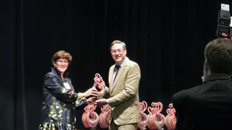 Nancy Barker accepts her Women in Leadership award on stage.