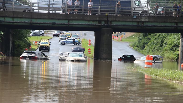 Submerged vehicles on flooded roadway.