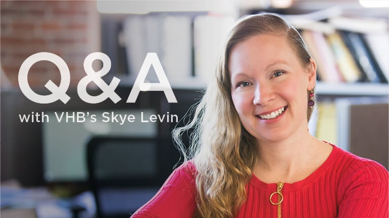 Skye Levin at a table in a VHB office.