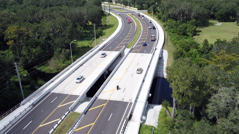 New twin bridges on Simpson Road with wide pathways for active transportation.