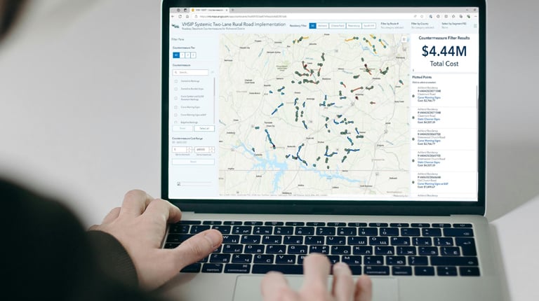 A laptop computer shows an ArcGIS dashboard with countermeasure locations and cost estimates.