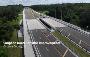 New twin bridges on Simpson Road with wide pathways for active transportation.