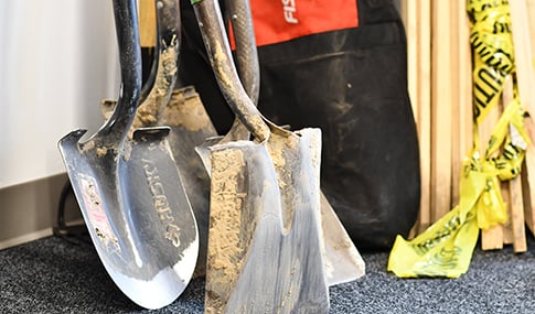 Shovels with dirt in an archaeology lab