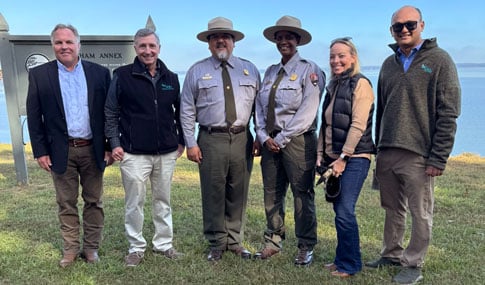 Project team leaders stand with NPS staff.