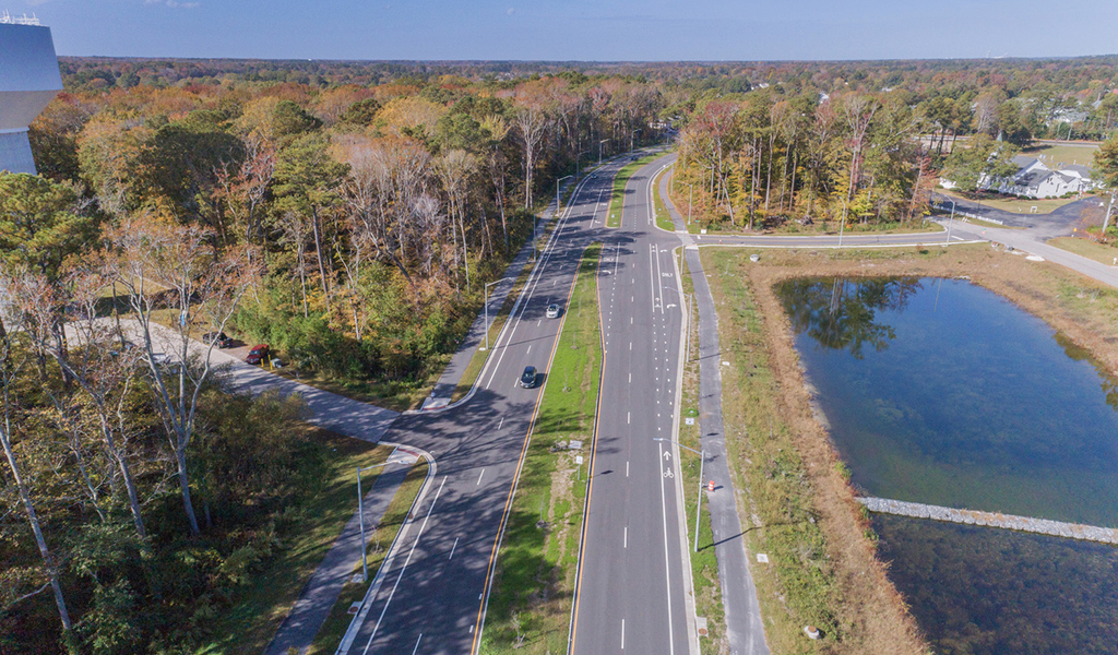 Aerial of four lane roadway with parallel multi-modal path.