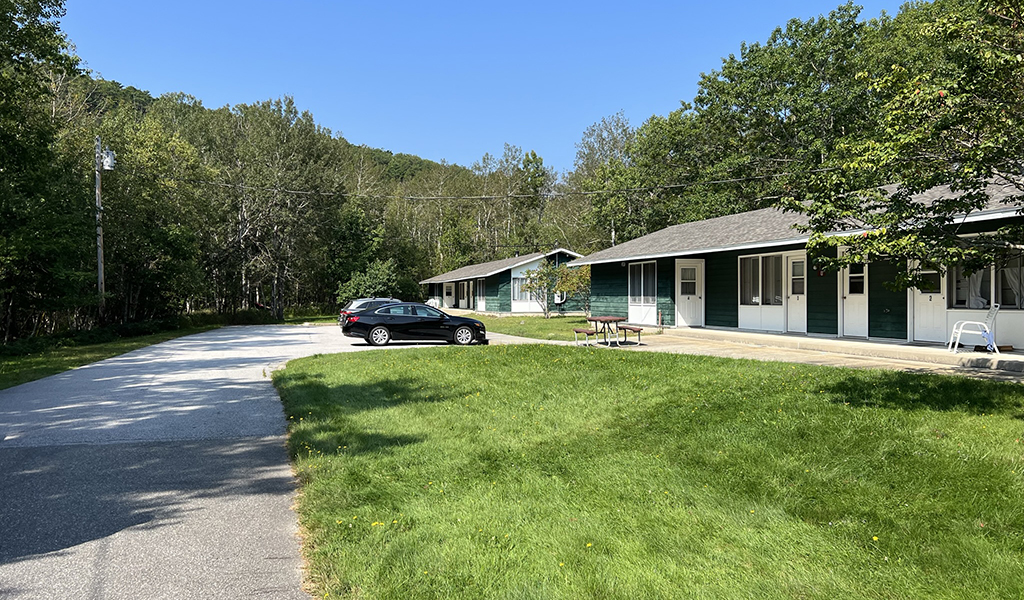 Harden Farm workforce housing buildings and parking area in tree-heavy setting.