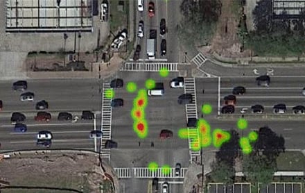 An aerial view of a heat map of a roadway intersection showing clusters of near-misses 