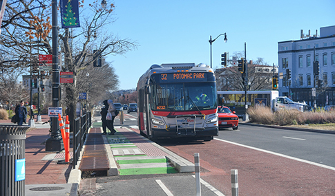 Pedestrians exit the bus on Pennsylvania Avenue SE. 