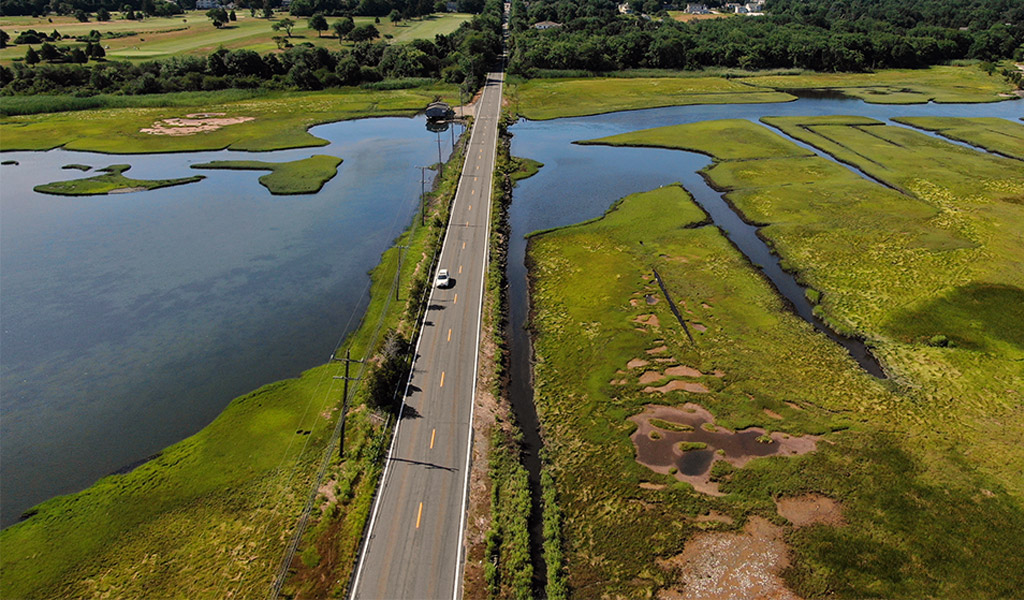 An aerial view of the Round Swamp Bridge over water in Jamestown.