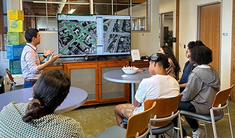 A small group of high school-aged students attending a mentoring presentation.