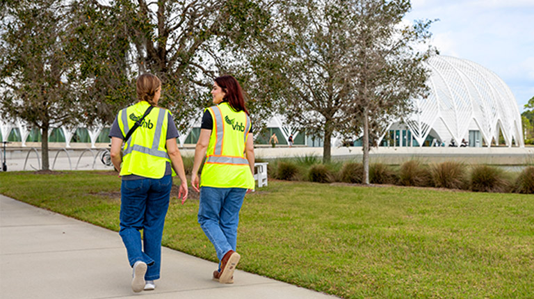 Rachel and a colleague in safety gear conducting a site visit at Florida Polytechnic University.