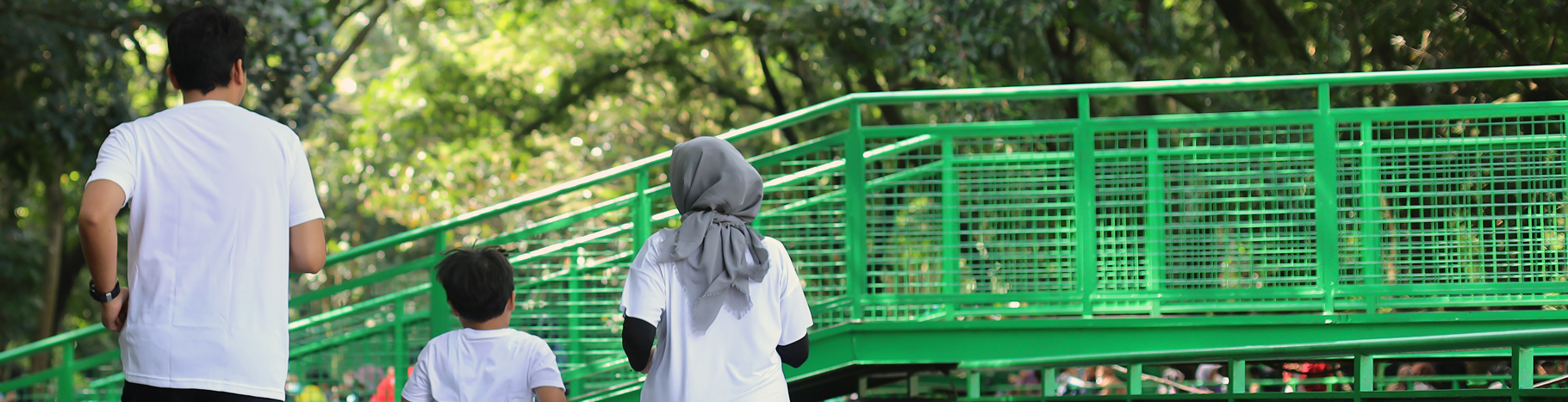 A Muslim family jogging in a park