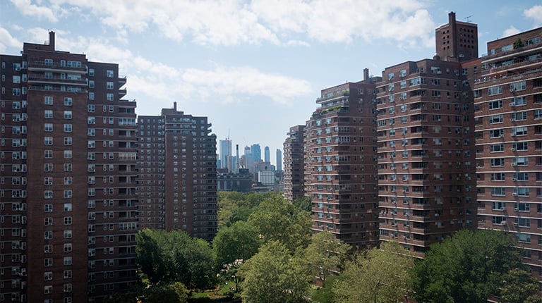 Large apartment buildings pictured from afar.